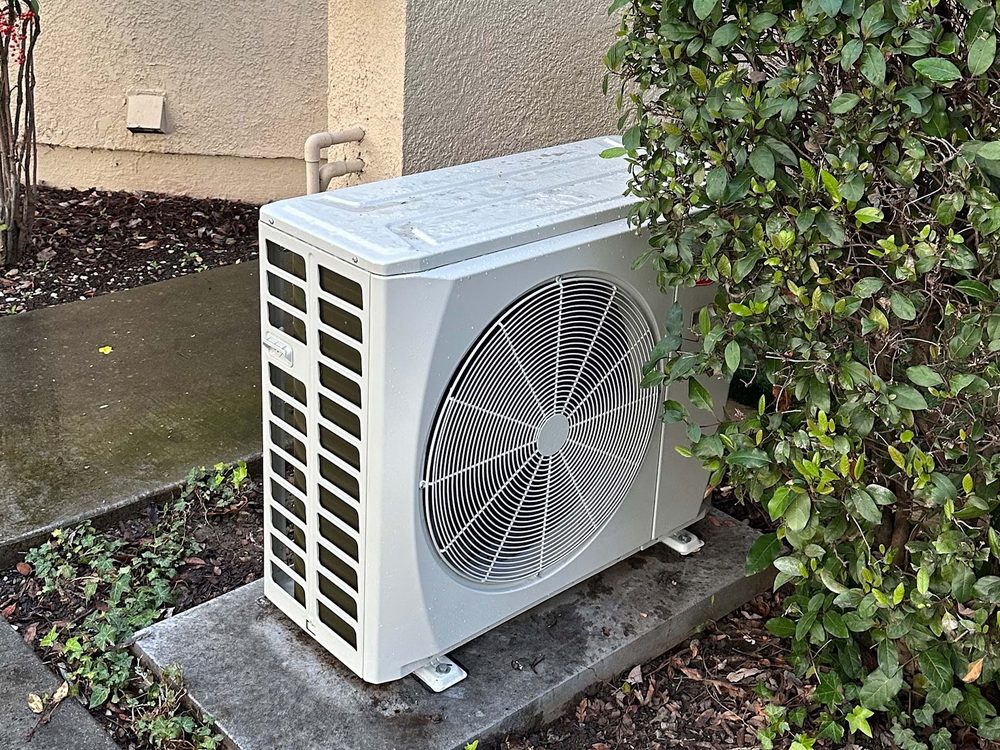 An outdoor condensing unit installed beside a Santa Clara home