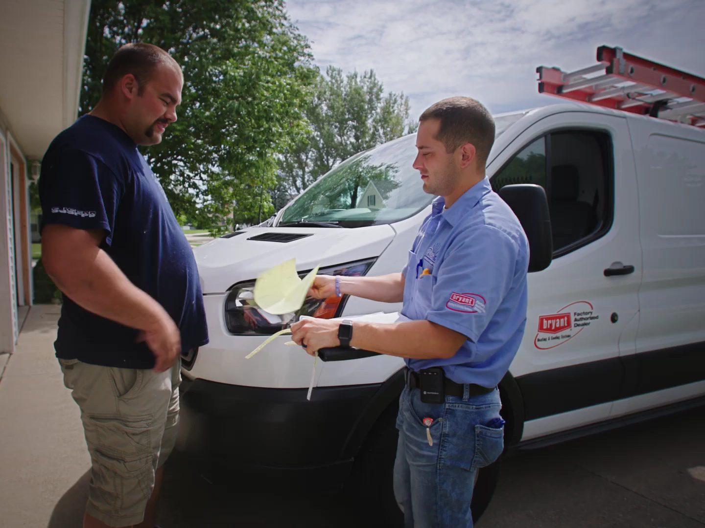 Two Made Simple technicians going over a job in front of the service vans