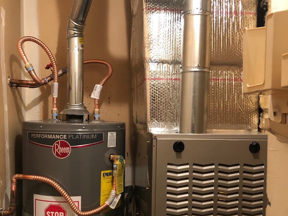 A furnace and water heater installation in a Bay Area utility closet